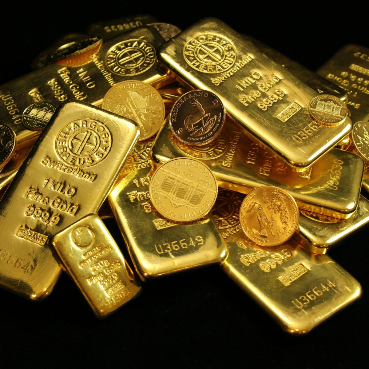 A collection of shining gold bars and coins symbolizing wealth and investment.